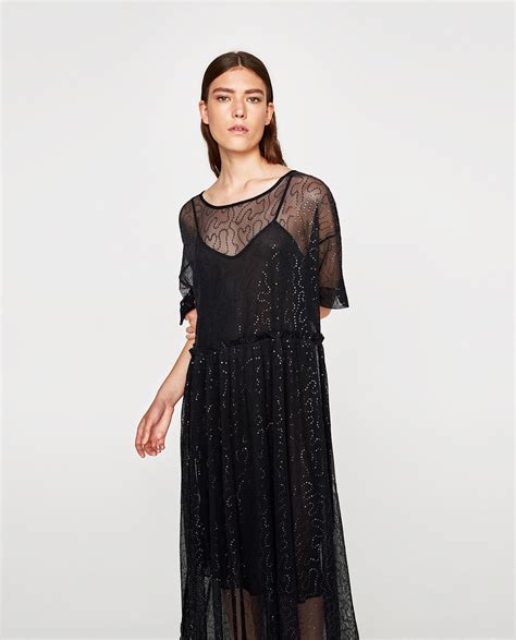 Tulle dress zara - Round neck tulle dress with long sleeves. Buttoned back teardrop closure. Flocked details. 